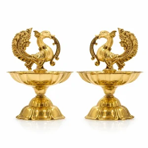 Close-up of ornate peacock design on antique brass oil lamp