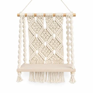 SPT Crafts white cotton macrame wall shelf with wooden platform on a white background