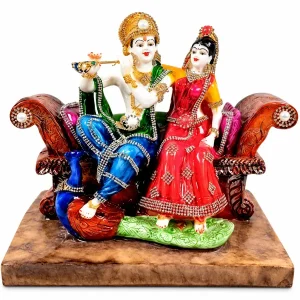 Apkamart Radha Krishna figures seated together on a decorative throne on a white background