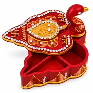 Open red leaf-shaped kumkum and chawal box with decorated peacock lid