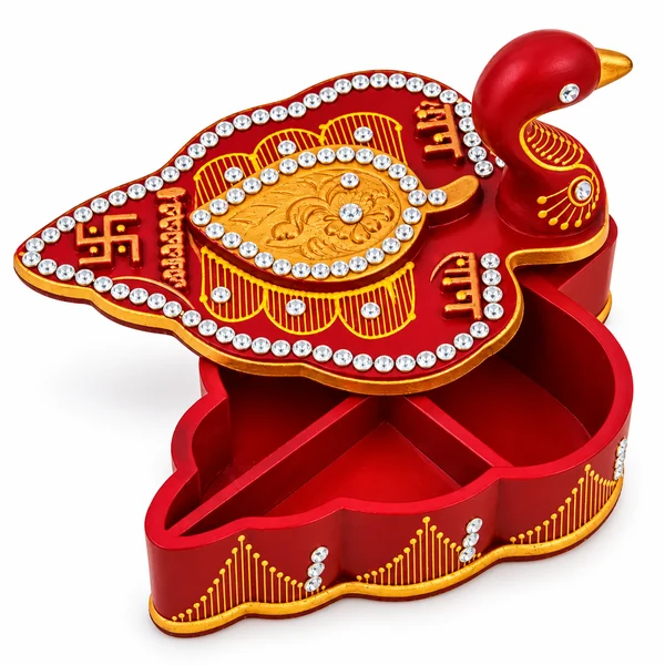 Open red leaf-shaped kumkum and chawal box with decorated peacock lid