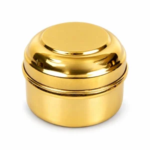Closed round brass kumkum container with fitted lid on white background