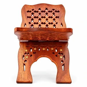 Empty carved wooden sacred book stand with diamond cutouts and gold stars