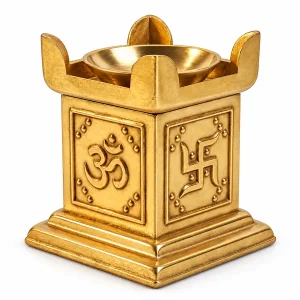 Brass Om havan kund style diya with raised panels and a round bowl on white
