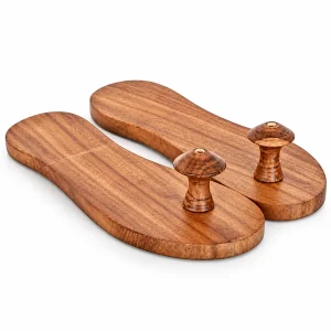 Pair of brown wooden khadau with raised toe pegs and plain wooden boards on white