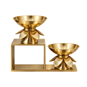 Integrated two-step brass lotus diya stand with two bowls on a geometric base on a transparent background
