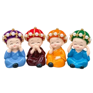 Four colourful hat baby monk resin figurines on a transparent background