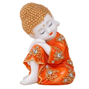 Orange resting baby monk figurine with gold floral details on a transparent background