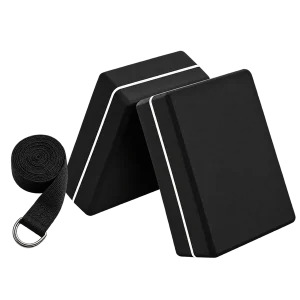 Two black EVA yoga blocks with rolled black strap on a transparent background